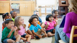 An audience of preschoolers listening to a story.